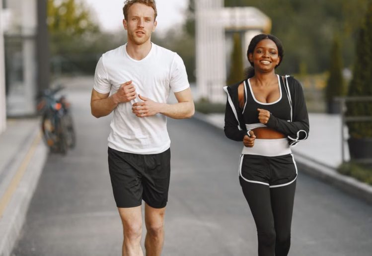 A man and woman jogging together outside, embracing a healthy lifestyle.